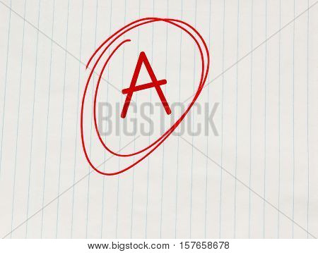 Grade A written in red on notebook paper