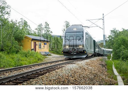 Flamsbana touristic mountain railway train at it's way to Kjosfossen waterfall. Flam, Norway.