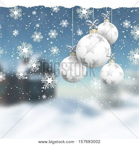 Hanging Christmas baubles on a defocussed winter landscape
