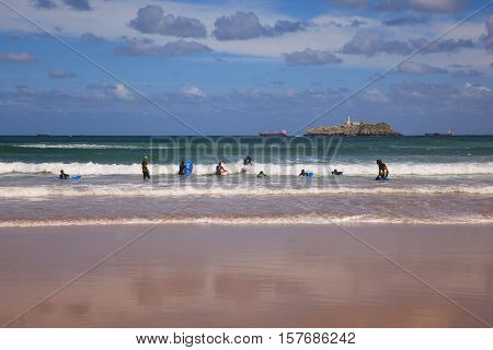 SANTANDER SPAIN - AUGUST 20: Boys teen surfing in Cantabrian sea on August 20 2016