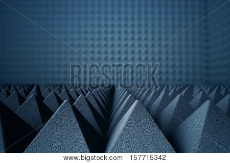 Abstract dark grey acoustic foam pyramids on dark background. 3D Rendering