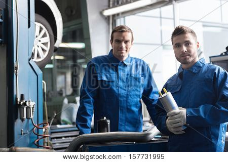Best service here. Pleasant confident car mechanics standing near car and going to repair it while working in auto service