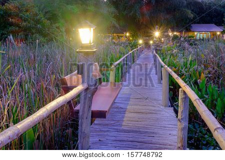 wood bridge use to walk into house and lamp during the walkway