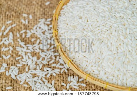Glutinous rice in bamboo Basket with hemp sacks background