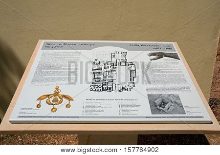 MALIA, CRETE - SEPTEMBER 14, 2016 - Information sign for the Palace of Malia Minoan ruins site showing the golden bee pendant Malia Crete Greece Europe, September 14, 2016.