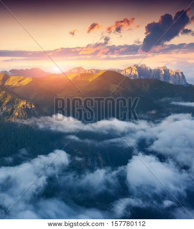 View of the foggy Val di Fassa valley with passo Sella. National Park. Dolomites South Tyrol. Location Canazei Campitello Mazzin. Italy Europe