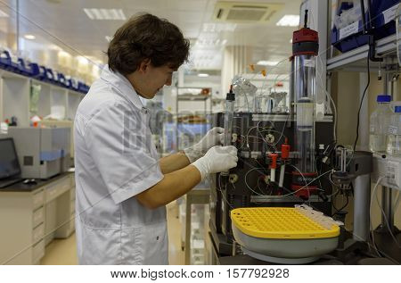 ST. PETERSBURG, RUSSIA - NOVEMBER 16, 2016: Researcher at work in the High-Throughput Biotechnology Laboratory of BIOCAD. It is one of the full-cycle drug development and manufacturing companies