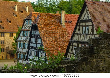 MAULBRONN GERMANY - MAI 17 2015: row of Tudor style houses at the monastery courtyard in Maulbronn. Cistercian Monastery Maulbronn is part of the UNESCO World Heritage Site.
