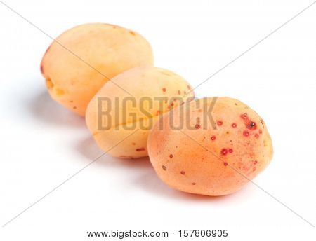 Real apricots isolated on white background