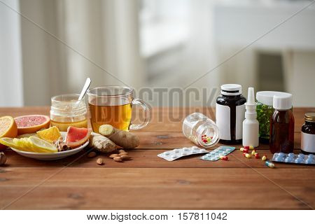 health, traditional medicine and ethnoscience concept - natural and synthetic drugs on wooden table