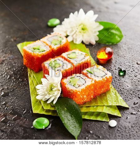 California Maki Sushi with Masago - Roll made of Crab Meat, Avocado, Cucumber, Japanese Mayonnaise inside. Masago (smelt roe) outside
