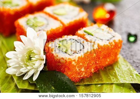 California Maki Sushi with Masago - Roll made of Crab Meat, Avocado, Cucumber, Japanese Mayonnaise inside. Masago (smelt roe) outside