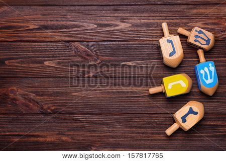 Dreidels for Hanukkah on wooden table