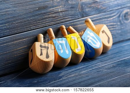 Dreidels for Hanukkah on wooden background