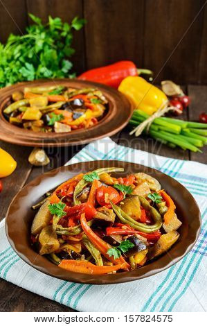Vegetable stew (salad): bell pepper eggplant asparagus beans garlic carrot leek. Bright spicy aromatic dishes. Menu of Italian cuisine.