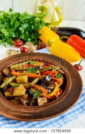Vegetable stew (salad): bell pepper eggplant asparagus beans garlic carrot leek. Bright spicy aromatic dishes. Menu of Italian cuisine.