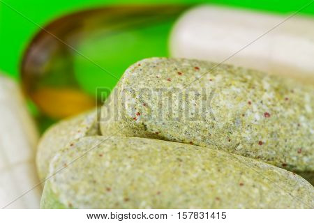 Mixed natural food supplement pills omega 3 multivitamin and glucosamine capsules macro image