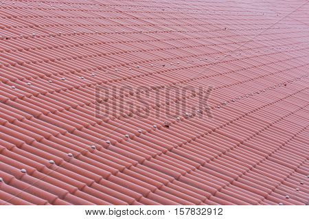 Close up of a roof with red tiles.