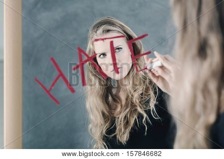 Girl with mental disorder writing word 