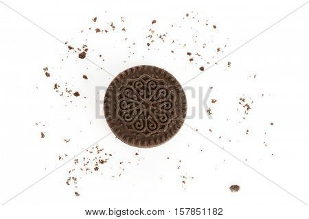Tasty cookie and crumbs on white background