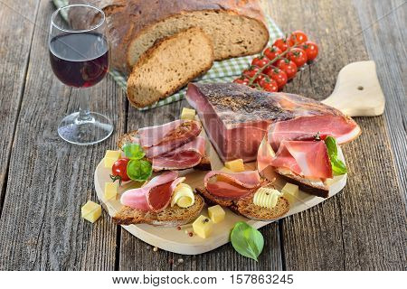 South Tyrolean bacon snack with fresh stone oven baked bread and mountain cheese cubes
