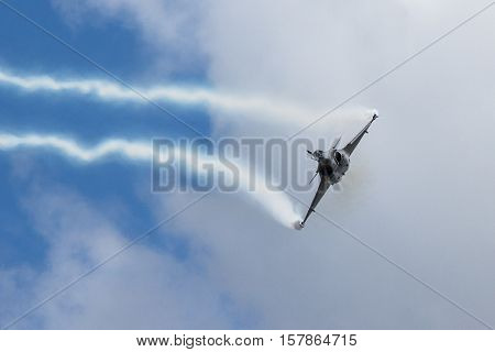 Fighter Jet flying straight at camera with contrails