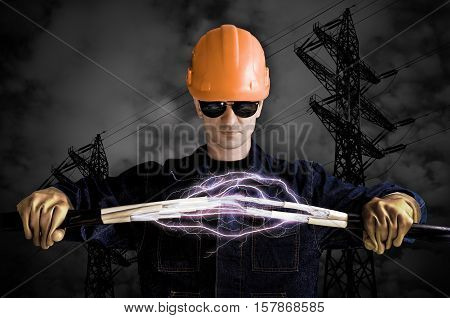 Electrician keeps cables that shoot lightning on the background of high voltage power lines