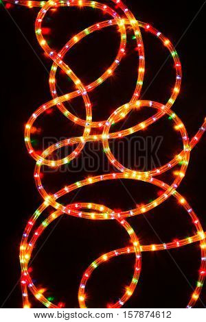 Rope lights. Colored lighted christmas stars garland illumination, lighted on black basckground. Christmas or other holiday decorations background