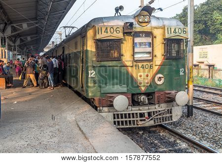 KOLKATA, INDIA - NOVEMBER 22, 2016: An intrastate morning local train boarding passengers at Lake Gardens station, Kolkata, India.