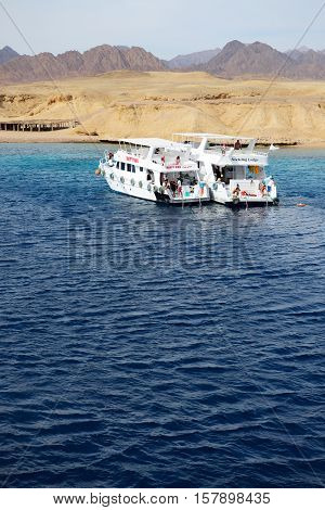 SHARM EL SHEIKH EGYPT - DECEMBER 4: Snorkeling tourists and motor yachts on Red Sea in Ras Muhammad National Park. It is popular tourists destination on December 4 2013 in Sharm el Sheikh Egypt