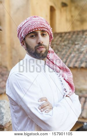 Young smiling handsome arabian man wearing traditional clothes