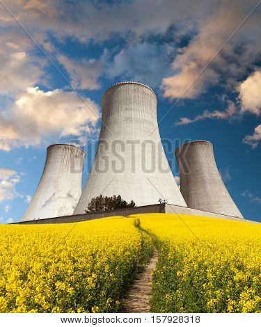 Nuclear power plant Dukovany with golden flowering field of rapeseed - Czech Republic - two possibility for production of energy