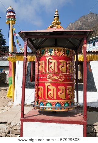 Prayer wheel in Tamo - monastery in Khumbu valley on three passes trek Mount Everest area Sagarmatha national park Nepal
