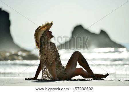 young woman relaxing on the beach in summer day