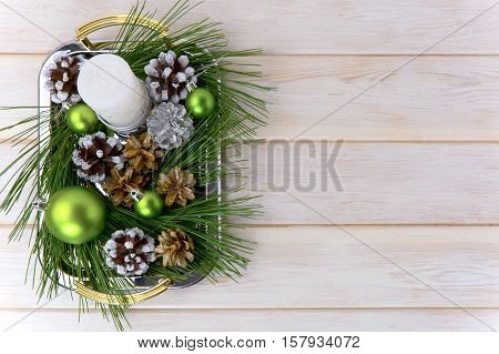 Christmas background with snowy pinecone decorated centerpiece. Christmas party decoration with green ornaments. Copy space.