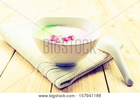 Tub Tim Krob ,Stuffed Water Chestnut in Syrup and Coconut Milk on wood table