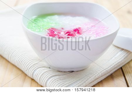 Tub Tim Krob ,Stuffed Water Chestnut in Syrup and Coconut Milk on wood table