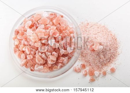 crystals of pink healthy himalayan salt in glass plate