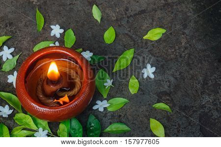 Candle light surrounding by dark nature and flower