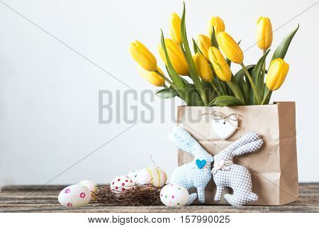 Easter Background Yellow Tulips On Wooden Table, Rabbit, Eggs,nest Candy