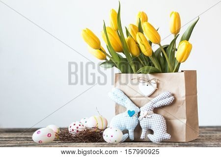 Easter Background Yellow Tulips On Wooden Table, Rabbit, Eggs,nest Candy