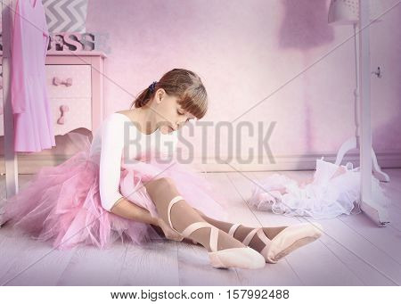 preteen girl in ballet class hall put on pointe shies prepare for classical dance lesson