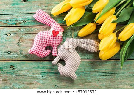 Easter Background Yellow Tulips On Wooden Table, Rabbit, Eggs,nest Candy