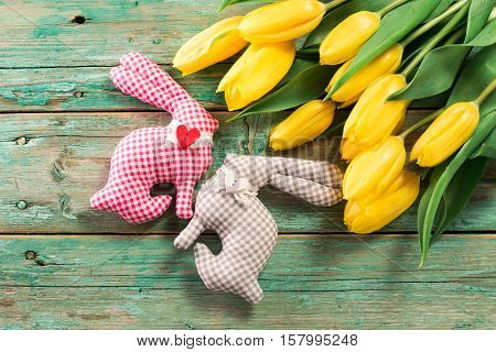 Easter Background Yellow Tulips On Wooden Table, Rabbit, Eggs,nest Candy