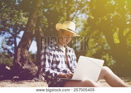 Young Male Travel Graphic Designer Freelancer Working With Lapop On The Beach
