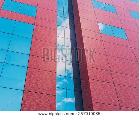 Red Office Building Reflect The Cloudsy Sky