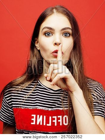 Young Pretty Teenage Girl On Bright Red Background, Happy Smilin