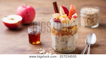 Overnight Oats, Bircher Muesli With Apple, Cinnamon And Honey. Wooden Background