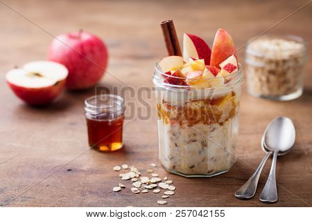Overnight Oats, Bircher Muesli With Apple, Cinnamon And Honey. Wooden Background