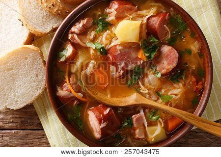 Czech Traditional Soup Zelnacka Of Sauerkraut With Sausages Close-up In A Bowl. Horizontal Top View